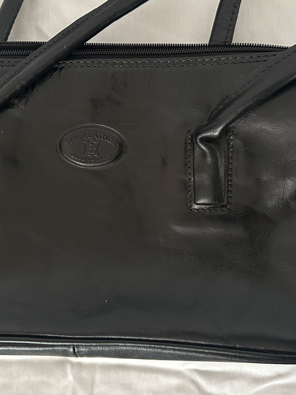 “Made in Italy” black leather bag.